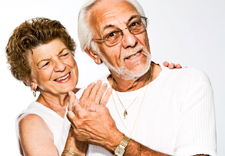 An elderly couple in the middle of a dance